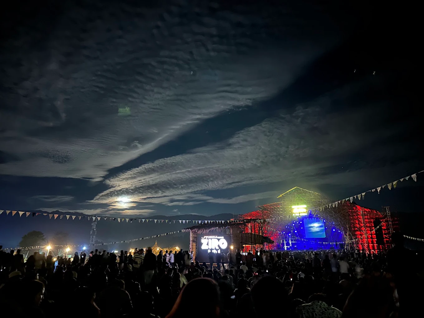 Ziro Music Festival in Ziro Valley, Arunachal Pradesh, featuring a live outdoor music performance surrounded by scenic mountains